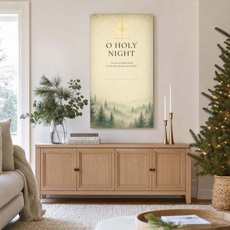 Styled room preview: Elegant O Holy Night typography canvas with refined serif lettering on softly aged cream vintage paper. A golden Star of Bethlehem shines above the words while a misty evergreen forest fades along the lower edge. Inspired by the Christmas carol composed by Adolphe Adam in 1847 and Luke 2:11, this warm neutral wall art brings reverent vintage character to seasonal decor.