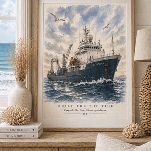 May include: Framed watercolour print depicting a navy blue ship, the "Sea Explorer", navigating choppy waters beneath a cloudy sky. The artwork includes the text "Built for the Tide". Seagulls are seen flying above.