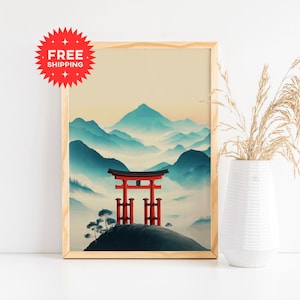 May include: A framed print featuring a Japanese landscape with a red torii gate atop a hill, set against a backdrop of blue mountains and a soft yellow sky. The artwork is in a minimalist style, with a "FREE SHIPPING" sticker in the upper left corner.