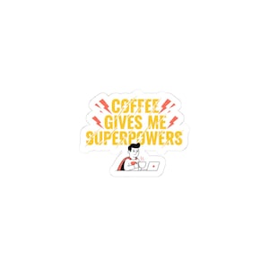 May include: A white sticker with the text "COFFEE GIVES ME SUPERPOWERS" in yellow and orange, with lightning bolt accents. A cartoon figure in a cape is drinking from a mug while working on a laptop.