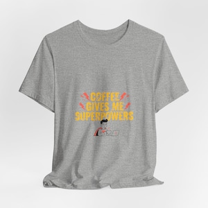 May include: A heather gray t-shirt with the text "COFFEE GIVES ME SUPERPOWERS" in yellow and red. The graphic includes a cartoon superhero with a laptop and coffee cup.