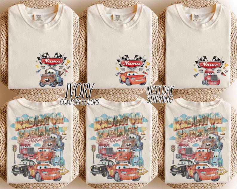 May include: Six ivory t-shirts featuring Disney Cars graphics. The top row shows individual characters with a checkered flag and a red banner labeled Name. The bottom row displays a large Radiator Springs scene with multiple characters and text.