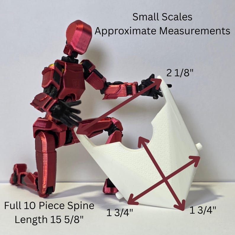 May include: A metallic red articulated robot figure kneeling and holding a white, diamond-shaped component. Text reads: Small Scales Approximate Measurements, 2 1/8", 1 3/4", 1 3/4", and Full 10 Piece Spine Length 15 5/8". Red arrows indicate dimensions.