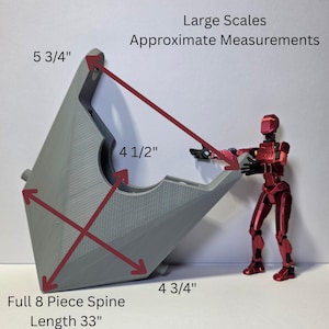 May include: A gray, angular, 3D-printed component with a textured surface, labeled Large Scales Approximate Measurements. Dimensions include 5 3/4 inches, 4 1/2 inches, 4 3/4 inches, and a full 8-piece spine length of 33 inches, shown with a red articulated figure.