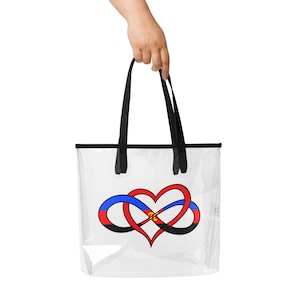 May include: Clear tote bag with black handles and trim. The bag features a heart-shaped infinity symbol in red, blue, and black, with a gold and black accent in the center. The bag is held by a hand.
