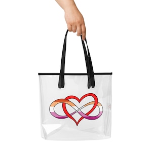 May include: Clear tote bag with black handles and trim. The bag features a red heart intertwined with an infinity symbol in orange, pink, and purple, symbolizing love and unity.