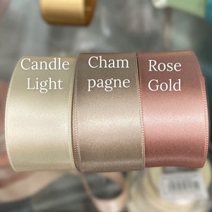 Rose gold, champagne and candlelight double faced ribbon in a luxurious fabric.  Use for wedding invitations, bouquet wrap, sashes, sold by the yard