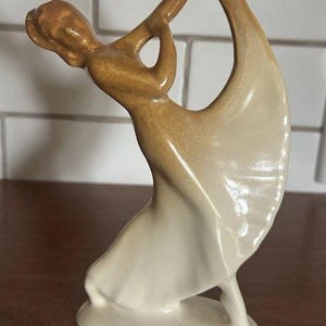 May include: A set of three ceramic mugs with a speckled, matte finish in cream, light grey, and dark grey. Each mug has a simple, minimalist design and a rounded handle.