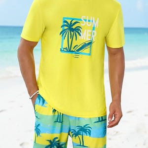 May include: Yellow crew neck t-shirt and matching shorts. The t-shirt features a blue square with a palm tree and surfboard graphic, with the word "SUMMER" printed in white. The shorts have a blue, green, and yellow striped pattern with palm trees.