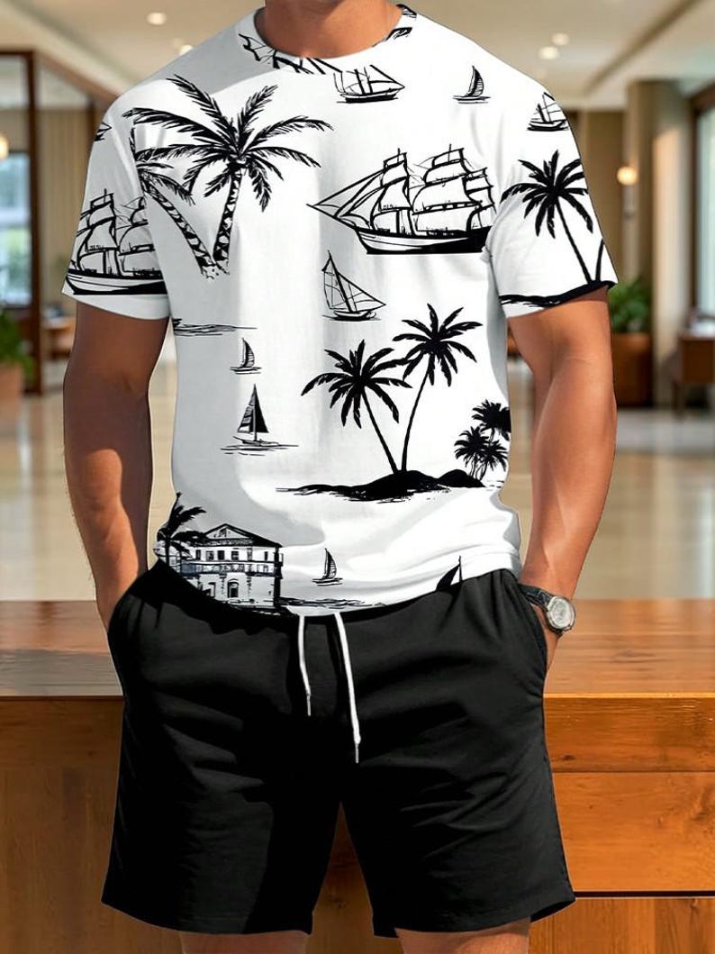 May include: White short-sleeved shirt and black shorts. The shirt features a black and white tropical design with palm trees, sailboats, and a building. The shorts have a drawstring and pockets. A watch is visible on the wrist.
