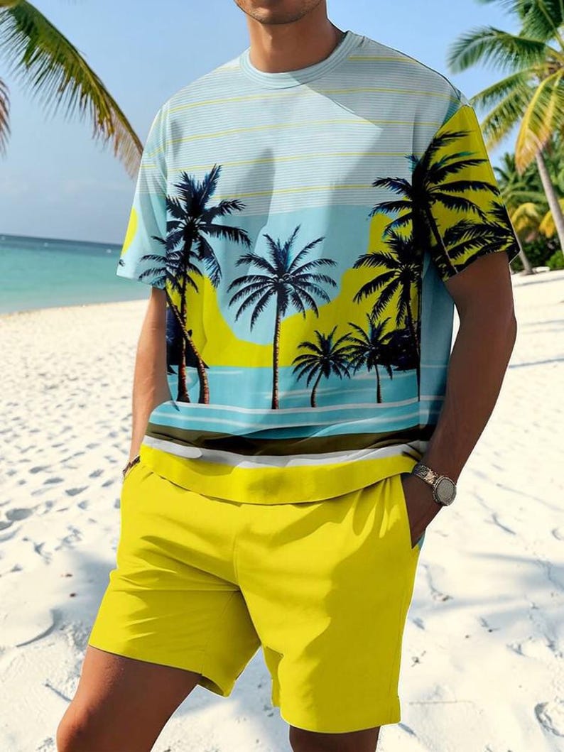 May include: A two-piece matching set featuring a short-sleeved t-shirt and shorts. The t-shirt has a beach scene print with palm trees and a blue and yellow color scheme. The shorts are solid yellow.