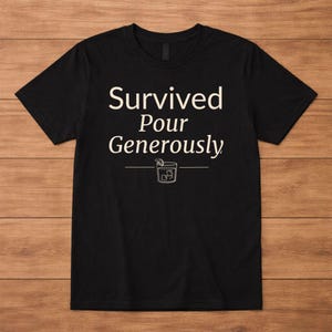 May include: Black t-shirt with the text "Survived Pour Generously" in white, above a line drawing of a cocktail. The shirt is a crew neck style.