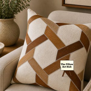 May include: A decorative pillow with a geometric pattern in shades of brown and cream. The pillow features a patchwork design with a variety of textures and tones. The Pillow Art Hub logo is visible on the pillow.
