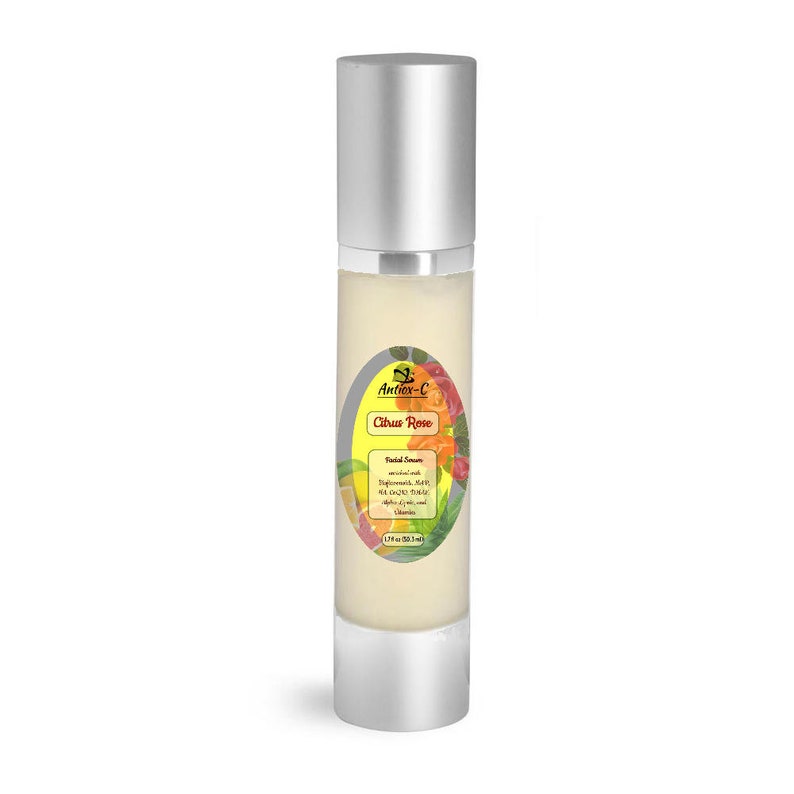 May include: A silver bottle of Citrus Rose facial serum by Antiox-C. The bottle has a label with a yellow and green logo and a colorful image of citrus fruits and roses. The label also includes the text "Facial Serum" and a list of ingredients.
