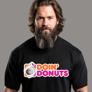 May include: Black t-shirt with the text "DOIN' DONUTS" in orange and pink, featuring a turbocharger graphic. The shirt is a crew neck style.