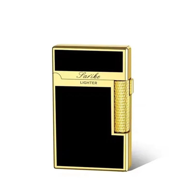 May include: A gold-coloured Sarike lighter with a black rectangular panel. The lighter has a textured, gold-coloured roller and the word "Lighter" is printed below the Sarike logo.