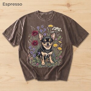 May include: Espresso-colored t-shirt featuring a detailed illustration of a black and tan Chihuahua surrounded by colorful wildflowers. The text "Espresso" is printed in the upper left corner. The shirt has a vintage, worn look.