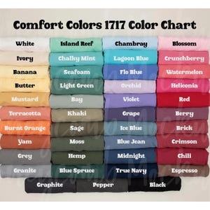 May include: A colour chart showcasing Comfort Colors 1717 fabric shades. The chart presents a range of colours, including white, blue, pink, green, and neutral tones. Each colour is labelled with its name, such as "Chambray" and "Berry".