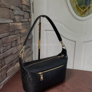 May include: A set of three ceramic mugs with a speckled, matte finish in cream, light brown, and dark brown. Each mug has a simple design and a rounded handle, perfect for tea or coffee.