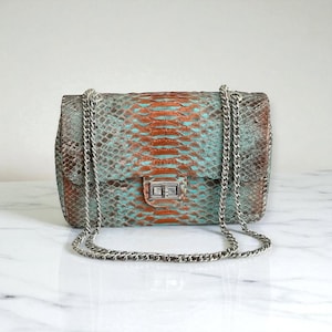 May include: A set of three ceramic mugs with a speckled, matte finish in cream, light brown, and dark brown. Each mug has a simple, minimalist design and a rounded handle.