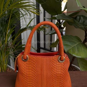 May include: A set of three ceramic nesting bowls in shades of blue, green, and white. The bowls have a speckled glaze and a simple, modern design. The largest bowl is approximately 18 cm in diameter.