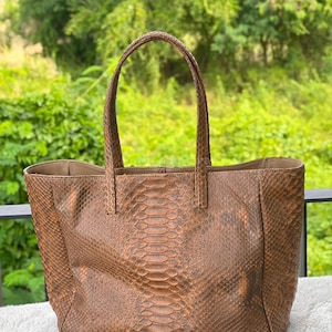 May include: A distressed wooden sign with the words "Welcome to our home" in white. The sign has a rustic finish, ideal for a porch or hallway, and a simple, welcoming design.