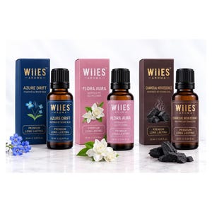 May include: Three amber glass essential oil bottles with black caps and matching rectangular boxes labeled WIIES AROMA. The scents are Azure Drift with blue flowers, Flora Aura with white blossoms, and Charcoal Noir Essence with charcoal pieces.
