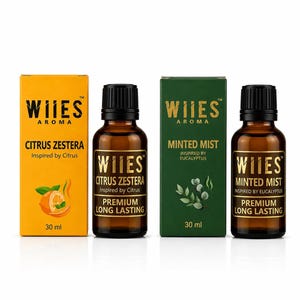 Può includere: Due flaconi in vetro ambrato con tappi neri e due scatole rettangolari. Una scatola è gialla con il testo Citrus Zestera e un'immagine di arancia. L'altra è verde con il testo Minted Mist e foglie di eucalipto. 30 ml per ogni flacone.