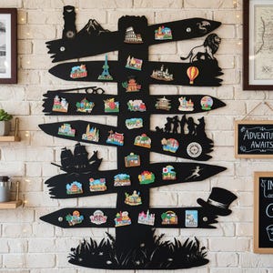May include: A black wooden signpost with various travel-themed magnets attached. The signpost features a mountain, a lion, and a top hat silhouette. The magnets depict landmarks like the Eiffel Tower and the Colosseum.