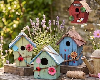 May include: Four wooden birdhouses in red, light green, mint green, and blue, featuring decorative garden tools, ladybugs, and floral accents. One red birdhouse is hanging, while the others sit on a wooden table with a spool of twine.