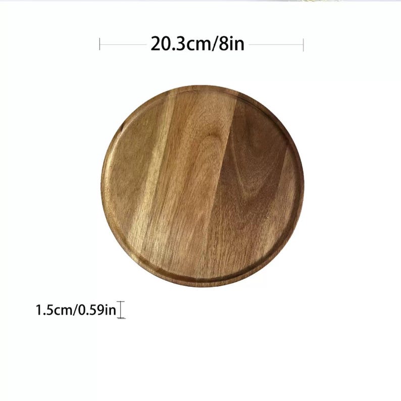 May include: A round wooden serving tray, 8 inches in diameter and 0.59 inches thick, with a natural wood grain finish. The tray has a slightly raised edge. The dimensions are displayed in both inches and centimeters.