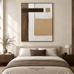 May include: A rectangular canvas painting featuring an abstract composition of thick, textured paint in shades of dark brown, white, and tan. The artwork displays a large vertical white stripe, a horizontal dark brown bar, and two tan squares.