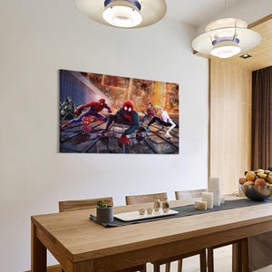 May include: A rectangular canvas print featuring multiple Spider-Man characters in action against a cityscape backdrop. The artwork showcases vibrant colors and dynamic poses, capturing a superhero theme. The print is displayed on a white wall above a wooden dining table.