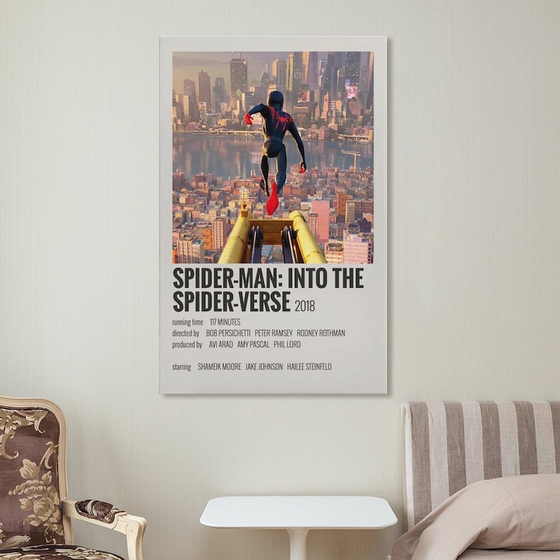 May include: A framed poster for the animated film "Spider-Man: Into the Spider-Verse" (2018). The poster features Spider-Man leaping over a yellow structure with a cityscape backdrop. The title and credits are displayed in white text.
