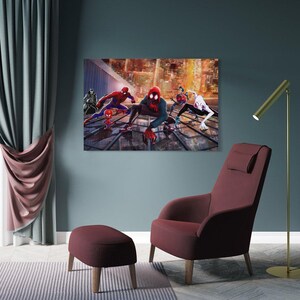 May include: A framed canvas art print featuring multiple Spider-Man characters in action against a cityscape backdrop. The artwork is displayed above a burgundy armchair and ottoman, with a gold floor lamp.
