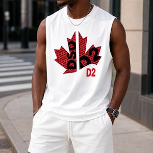 May include: A white sleeveless tank top featuring a large red maple leaf graphic on the chest. The leaf is filled with a repeating black text pattern and the letters DSQ2. The text D2 is printed in red below the maple leaf graphic on the shirt.