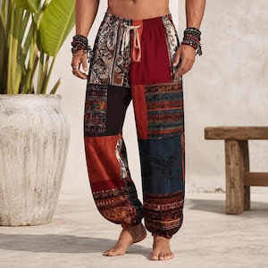 May include: Loose-fitting trousers featuring a patchwork design with various panels in shades of deep red, navy blue, and orange. The pants include an elastic waistband with a light-colored drawstring and cuffed ankles, showcasing intricate patterns.