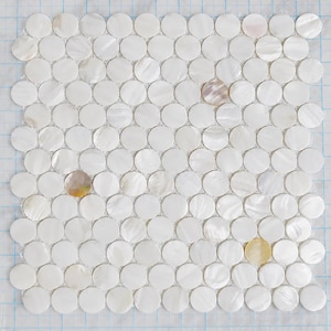 May include: A square mosaic tile sheet composed of numerous small, circular white mother-of-pearl pieces arranged in a grid pattern. The iridescent shell discs are mounted on a clear plastic backing with a blue grid alignment guide printed on it.