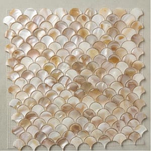 May include: A mosaic tile sheet featuring a fan-shaped design in shades of white, beige, and gold. The tiles are arranged in a repeating pattern, creating a textured surface. The tiles are mounted on a mesh backing.