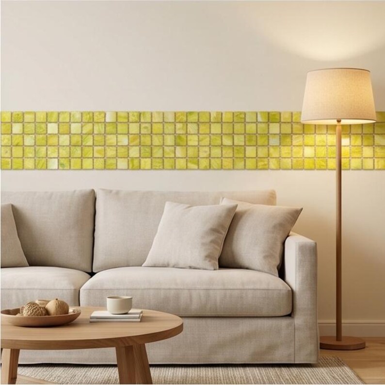 May include: A horizontal border of square, translucent lime green glass tiles applied to a wall. The tiles feature a grid pattern with subtle variations in color intensity, creating a textured, reflective surface across the wall's midsection.