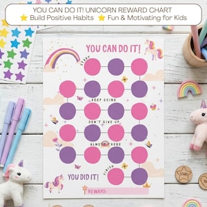 Puede incluir: Una tabla de recompensas con temática de unicornio que presenta una cuadrícula de círculos rosas y morados, un arcoíris y el texto YOU CAN DO IT. La tabla incluye secciones etiquetadas como START, KEEP GOING, DON'T GIVE UP, ALMOST THERE, FINISH y REWARD.