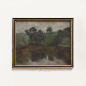 May include: An antique landscape painting in a dark wooden frame. The artwork depicts a serene scene with trees, a body of water, and rolling green hills under a cloudy sky. The painting has a vintage aesthetic.