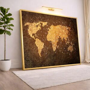 May include: A framed world map art print. The map is rendered in gold glitter against a dark brown background. White connecting lines and dots overlay the continents. The frame is gold.
