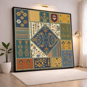 May include: Large framed artwork with a patchwork design. It features floral and geometric patterns in blue, orange, yellow, and green. The artwork is displayed on a white rug and has a black frame.