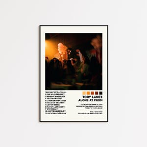May include: A framed poster featuring the album art for Tory Lanez's "Alone at Prom." The poster has a photograph of a concert scene with a warm color palette. The album title and tracklist are displayed in a minimalist design.