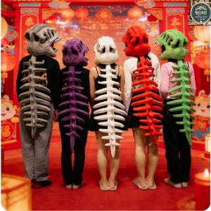 May include: Five people wearing dinosaur skeleton costumes. Each costume features a plush dinosaur head and a matching spine that extends down the back. The costumes are in shades of gray, purple, white, red, and green.