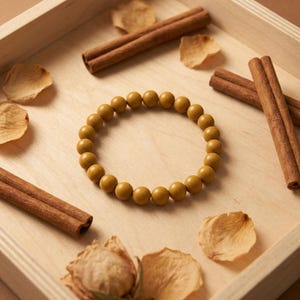 May include: A white ceramic mug with a black handle and the text "But First, Coffee" in a black, bold font. The mug is on a white surface. The mug is 4 inches tall.