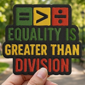 May include: Embroidered patch with the text "EQUALITY IS GREATER THAN DIVISION." The patch features green, yellow, and red blocks with mathematical symbols. The patch is black with green, yellow, and red text.