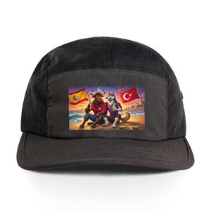 May include: Black five-panel cap featuring a vibrant graphic. The graphic shows a bull and a wolf on a beach, with Spanish and Turkish flags. The bull and wolf are holding bottles. The cap has a curved peak.