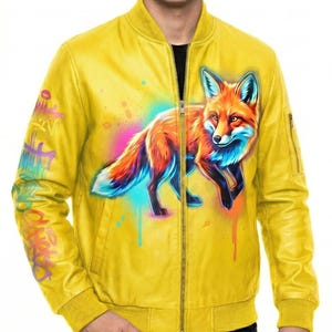 May include: Yellow bomber jacket with a vibrant fox graphic. The jacket features a full-zip closure, ribbed cuffs, and a colorful fox illustration on the front. The sleeves have graffiti-style artwork. A stylish outerwear piece.
